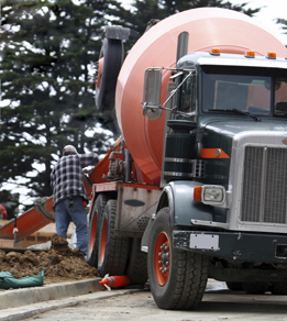 This photo is of a concrete truck unloading its cargo.