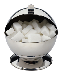 This photo is of a silver sugar bowl filled with sugar cubes.