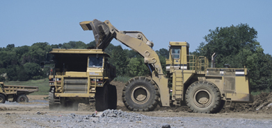This photo shows a road construction crew moving earth.