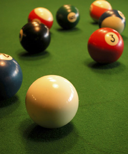 This is a photo of pool balls on a pool table. 