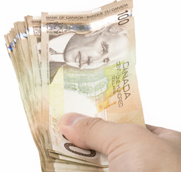 This is a photo of a hand holding a stack of 100-dollar bills.