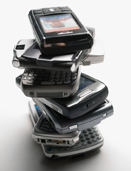 This photo shows a stack of cellphones.