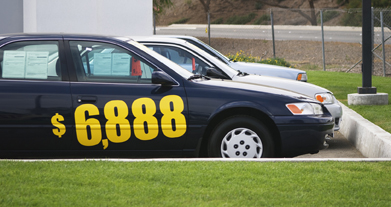 This is a picture of a car with “$6,888” painted on the side.