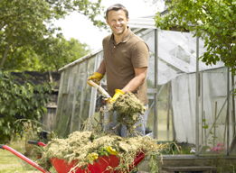 This is a picture of a man loading a wheelbarrow.