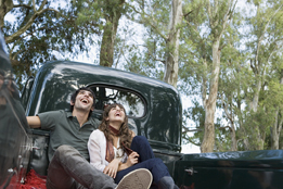 This is a photo of a young couple in the back of a pickup truck.