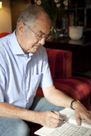 This is a photo of a man playing Sudoku.