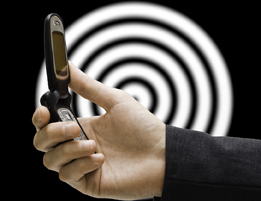 This is a photograph of a person holding a cellphone with a design containing concentric circles in the background.