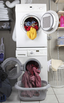 This is a photo of a stacked washer and dryer with their doors open and clothes spilling out.