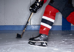 This image shows one leg of a hockey player while stick handling the puck.