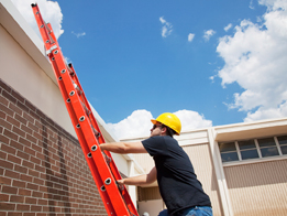 This is a photo of a worker climbing up a ladder.