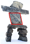 This photograph shows an inukshuk with a quadrilateral outlined in red.