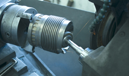 This is a photograph of a machining lathe that is turning steel in a manufacturing plant. 