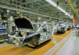 This is a photograph of an assembly line for manufacturing cars.