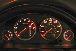 This picture shows the dashboard of a vehicle with a temperature gauge, a tachometer, a speedometer, and a fuel gauge.