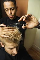 This is a photograph of someone having their hair cut with scissors.