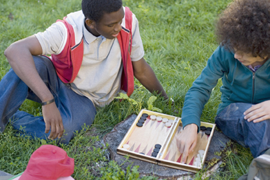 The picture is of two boys playing backgammon.