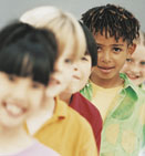 This is a photo of kids standing single file in a line.