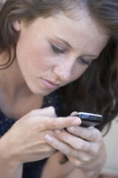 This is a photo of a girl looking at her cellphone.