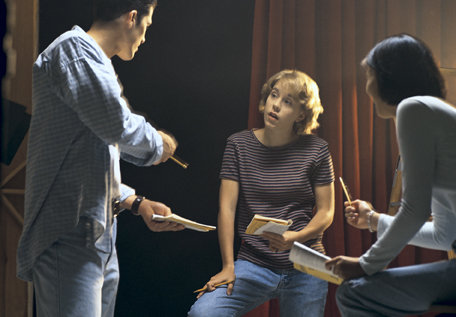 This is a photo of a director speaking to two actors.