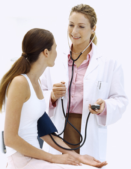 This is a photo of a medical professional taking the blood pressure of a young female.