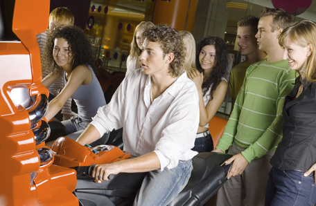 This is a picture of a group of people playing a simulator race game.