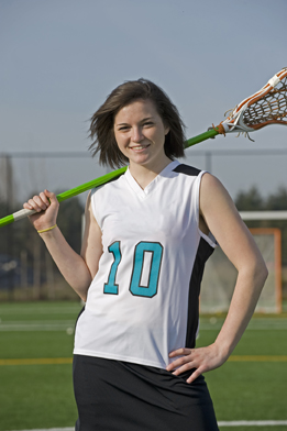 This is a photo of a girl holding a lacrosse stick.