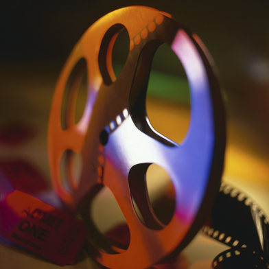This is a photo of a film reel and an admittance ticket.