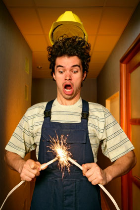This is a photo of a young man getting a shock from exposed electrical wires.