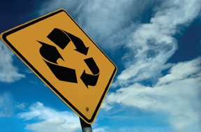 A photograph shows a recycle sign.
