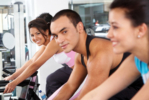 A group of young people are shown working out in a fitness centre.