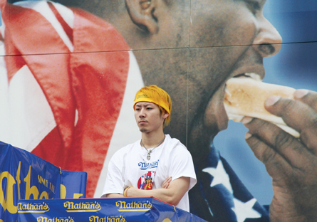 This photo is of Takeru Kobayashi at a hot dog eating contest.