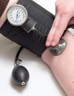 This photo is of a blood-pressure cuff on someone’s arm. A stethoscope is being used at the elbow.