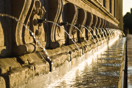 A photo of a row of fountain faucets.