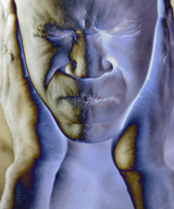 A shadowy image of a human covering its ears with its hands, attempting to protect the person from a loud sound.