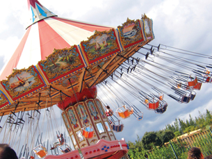 A photograph of the swings on a tilt-a-whirl carnival ride.