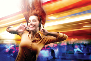 A photograph shows a young female wearing headphones and dancing.