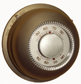 This photograph shows an old-fashioned round thermostat control. The regulation of temperature in your house is similar to negative feedback systems in your body.