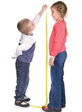 The photo shows children measuring the increase in their height as a result of hGH causing the growth of the long bones in their bodies.