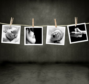 This image shows four black-and-white photographs hanging from clothes pegs on a cord. The photographs show, from left to right, a baby’s face, a pregnant belly, a yawning or crying baby, and a, mother’s hand holding a baby’s feet