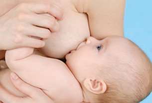 This photograph shows a baby nursing. 