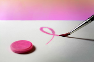 This photo shows a painted pink breast cancer ribbon.