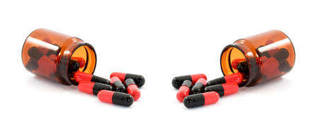 The photo shows a two pill bottles with antibiotics spilling out.