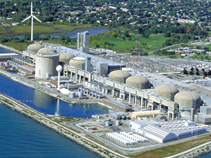 This picture of a nuclear power plant was taken from a plane. The plant consists of 8 large dome-shaped reactor buildings and other structures.
