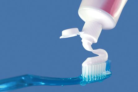  A photograph shows toothpaste being applied to a toothbrush
