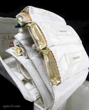 A photograph of the medical supply kit used in the Apollo spacecraft. The kit contains a roll of pouch pockets, each containing types of medicines in foil-wrapped packages.