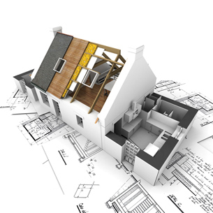 A photograph of a model house appears on top of architectural drawings of the house’s design.