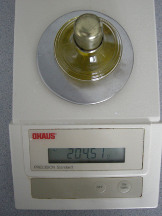 Photo 10: This photograph shows the spirit burned filled with olive oil on the balance, so that the final mass can be recorded.