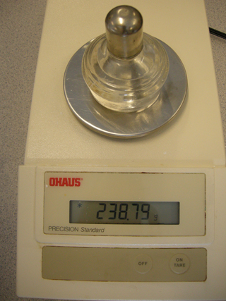 Photo 14: This photograph shows the spirit burner filled with methanol on the balance so that the final mass can be read.