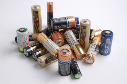 A photograph shows many commercial batteries of various sizes and shapes.