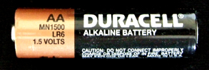A photograph shows a consumer cell with a label that indicates that the cell is an alkaline battery.